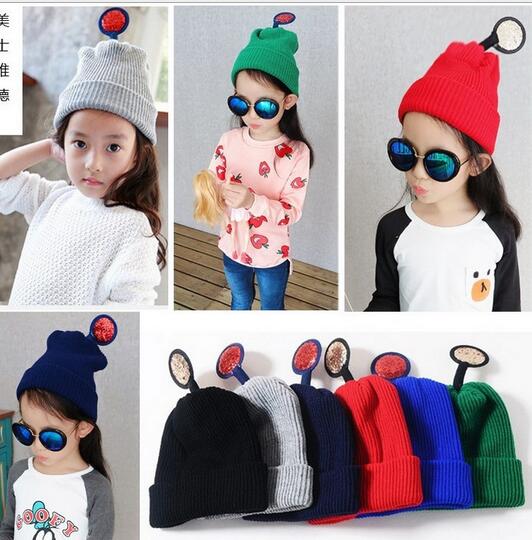With wrapped rim and top antenna shape knitted children cap