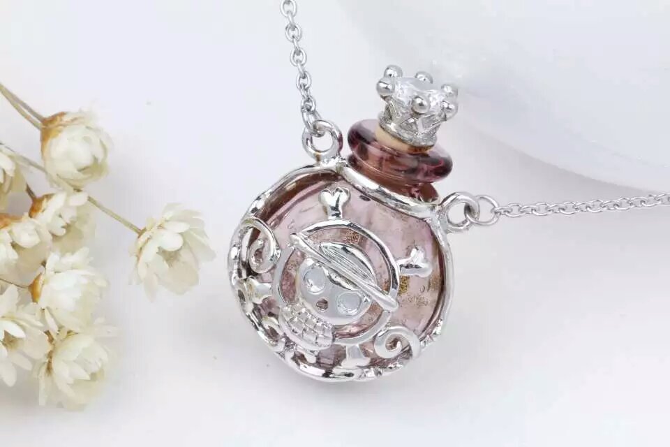 Wholesale human skeleton shape metal alloy box essencial oil brown color bottle necklace with crown lid
